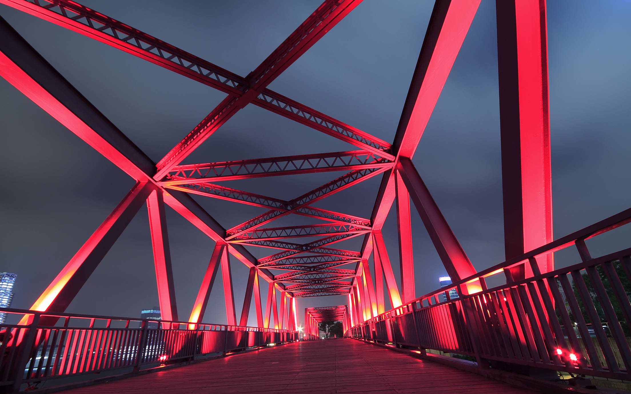 Steel bridge lightened up by red light in the night time