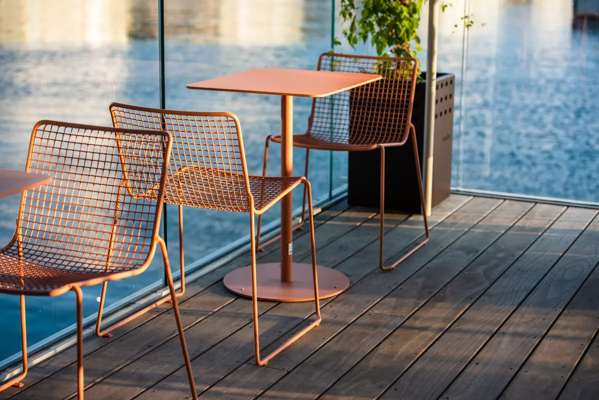 2 steel chairs and table on pool deck