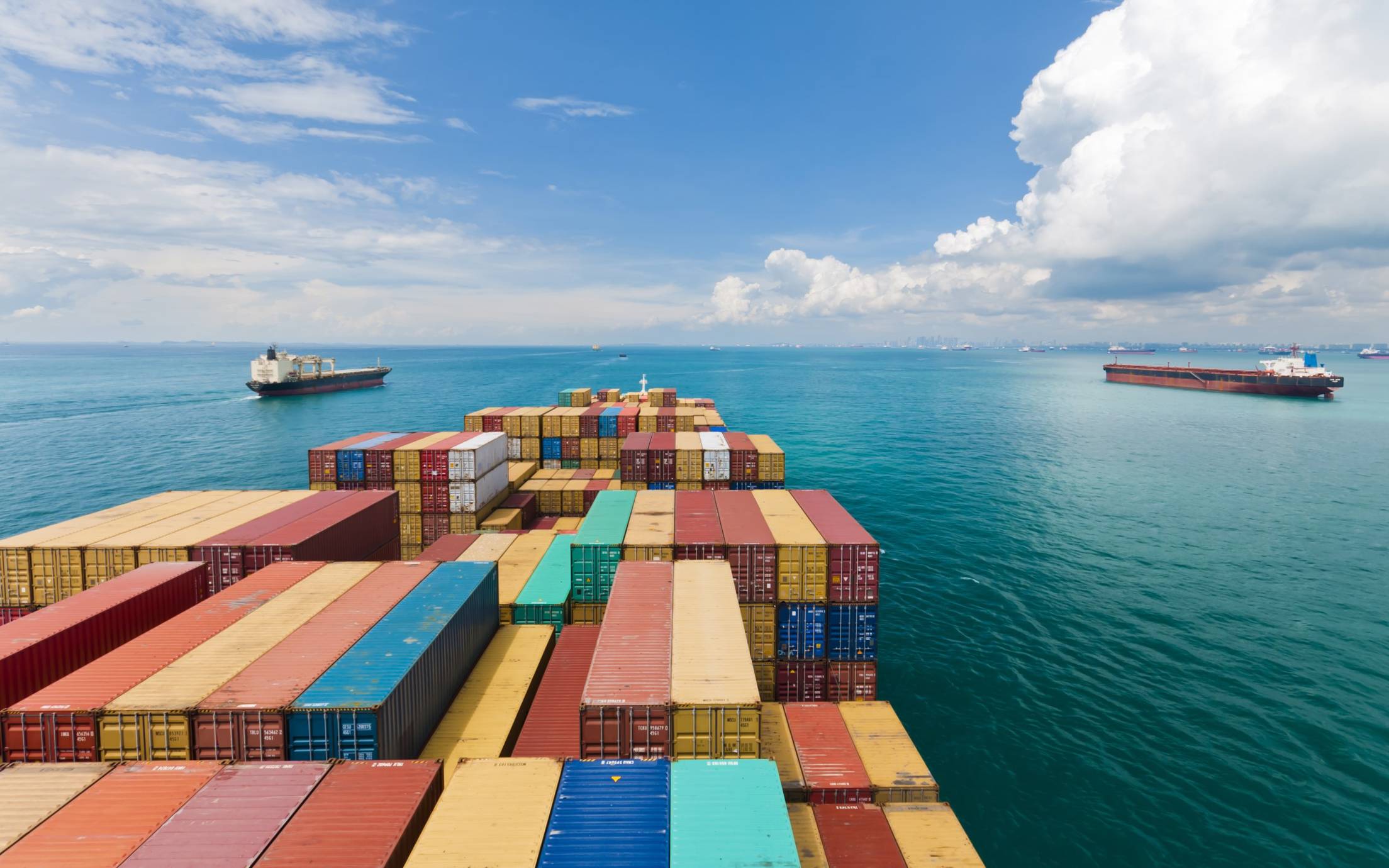 Container ship and two other ships at sea