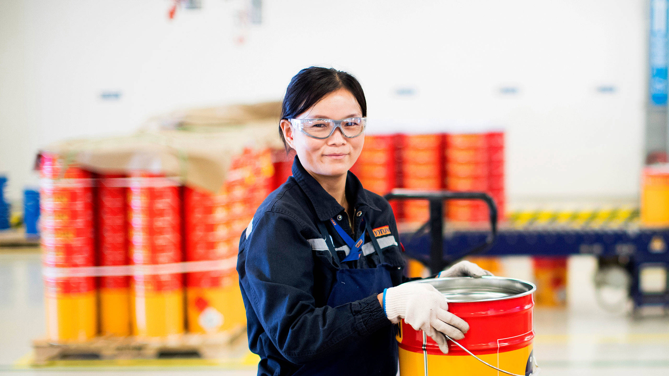 Female factory worker with a Jotun can